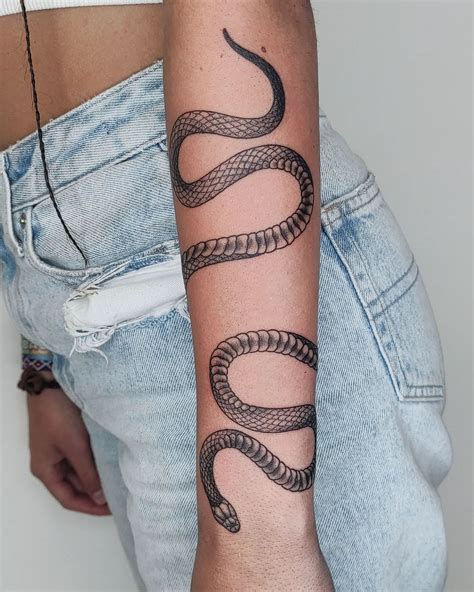 wrap around snake tattoo arm|Snake wrapping around arm tattoo